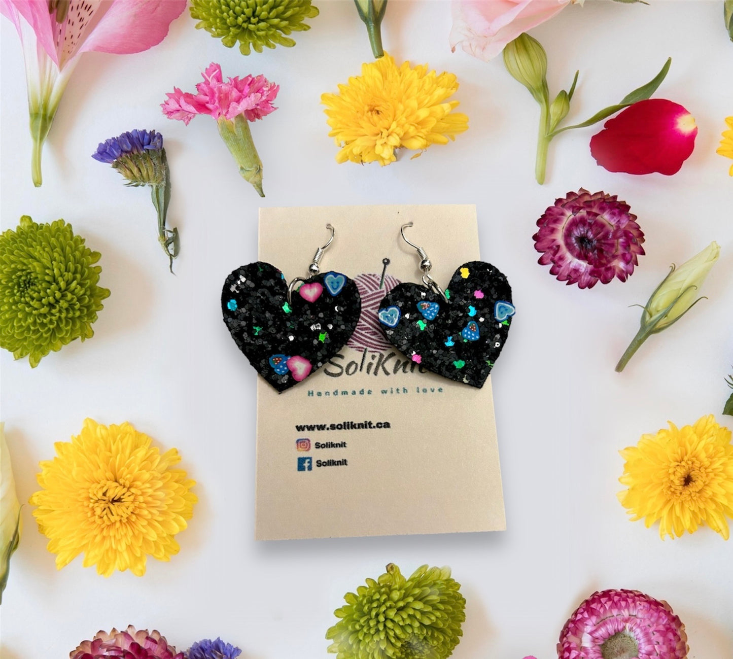 Black glitter heart leather earrings
